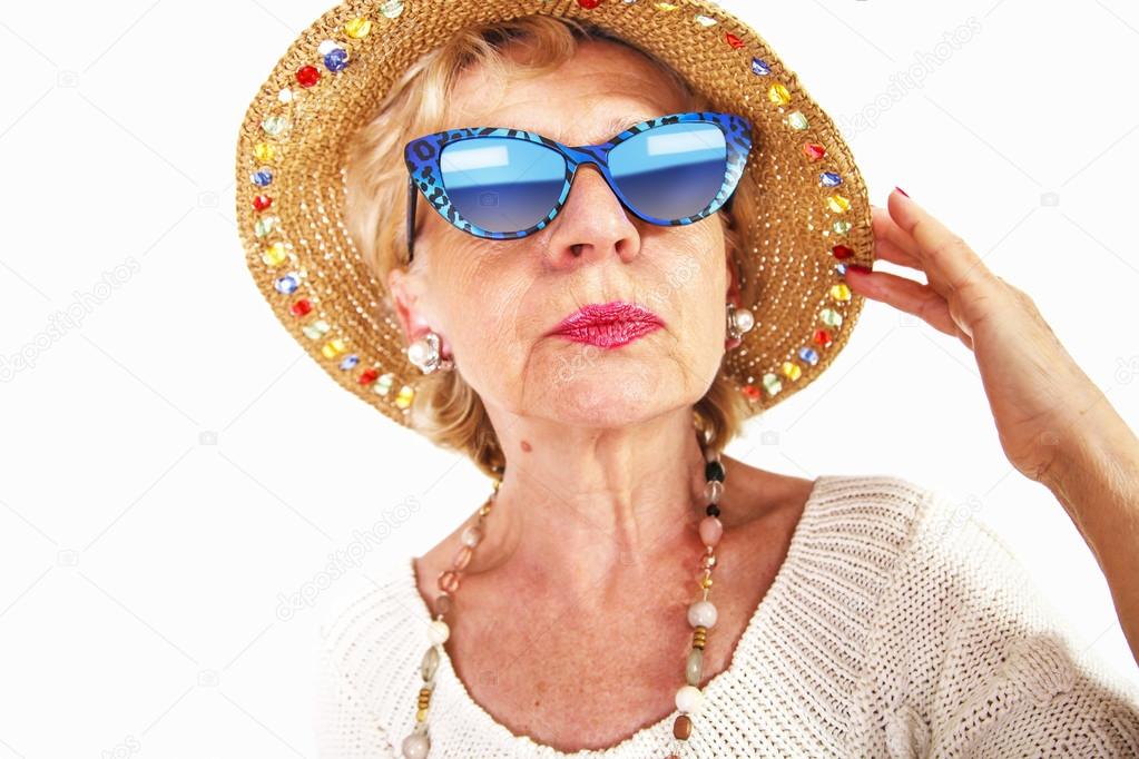 Senior woman wearing sunglasses and hat
