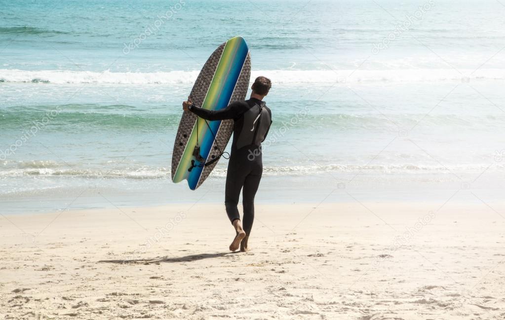 Young surfer on the beach