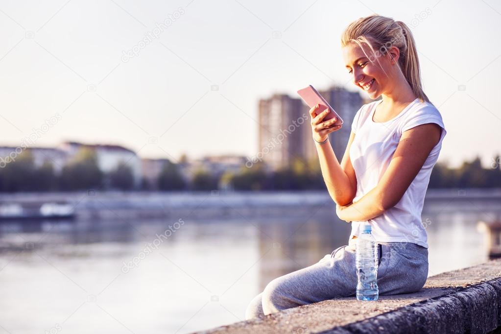 Teenage girl texting message, outdoor
