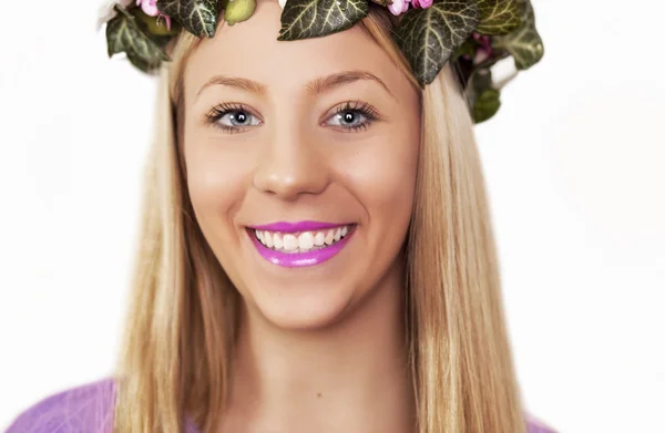 Beautiful girl with wreath of flowers in her hair — Stock Photo, Image