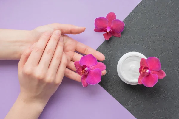 Cosmetic Background Hands Soft White Cream Fragile Magenta Colored Orchids — Stock Photo, Image
