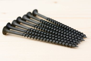 Ahşap arka planda birkaç tane uzun vida var. Çalışmaları onarmak, yerleştirmek ve onarmak için ekipman grupları