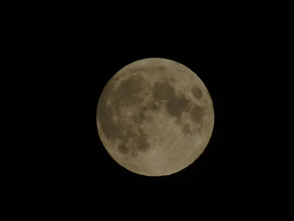 Genova, Italy - 09/25/2020: An amazing photography of the full moon over the city of Genova by night with a great clear sky in background and some stars