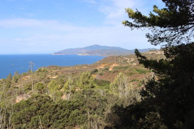 Elba, İtalya 01 Eylül 2021: Elba Adası 'ndan güzel yerler. Adanın havadan görüntüsü. Sahillerin yakınındaki küçük ünlü köyler. Yaz turistik yerleri. Arka planda bulutlar ve mavi gökyüzü.