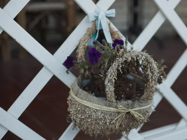 Mand met bloemen op een witte hek — Stockfoto