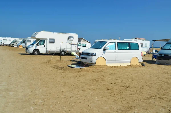 caravans cars parked on the beach of prasonisi in rhodes, summer holidays in  island greee