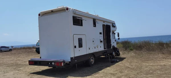 caravan car by the sea in summer beach trees blue sky  travel in holidays