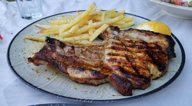 Patates ve mantarlı biftek ve tabakta tuz biberiyesi