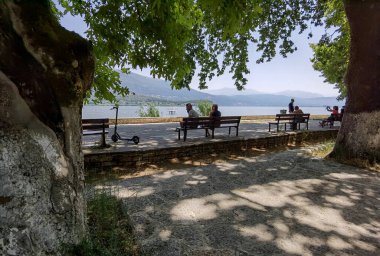 Pamvotis Gölü kıyısındaki ioannina şehri, yaz mevsiminde, yeşil platanus ağaçları göl tekneleri, Yunanistan