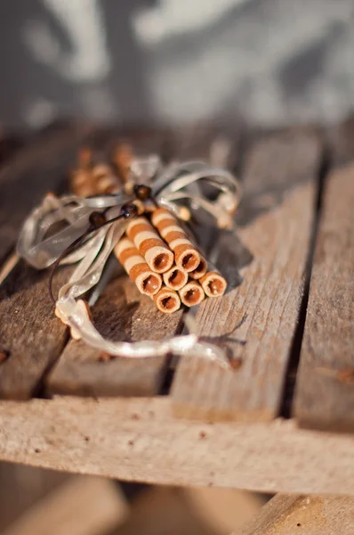 Wafer rolls on a wooden board — Stock Photo, Image