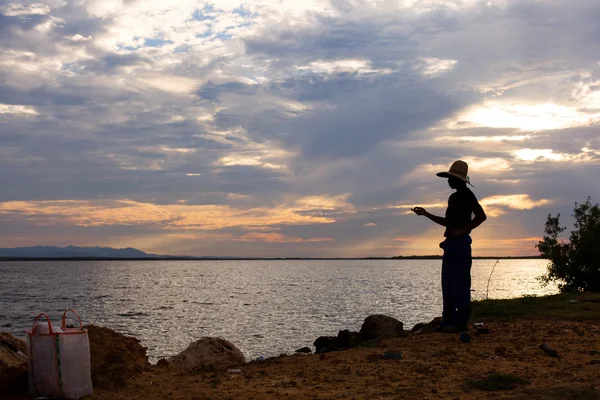 Silhouette of a man fishing with hand in Cuba — Stock Photo, Image