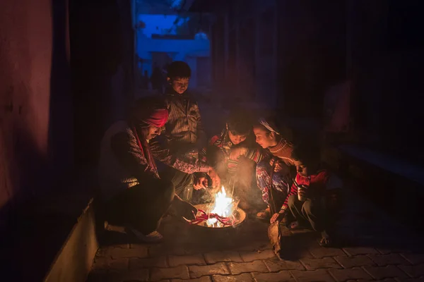 AGRA, INDIA - JAN 09: People making fire to warm in a street of Agra on January 09, 2015. Agra is a city on the banks of the river Yamuna in the northern state of Uttar Pradesh, India.