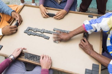 Cropped image of people playing domino on street clipart