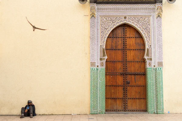 FEZ, MOROCCO - APRIL 15: Unkown man relaxing near to entrance of — Stock Photo, Image