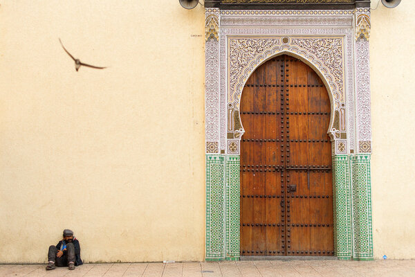 FEZ, MOROCCO - APRIL 15: Unkown man relaxing near to entrance of