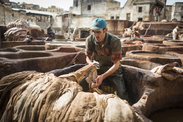 FEZ, MOROCCO - 19 апреля: Работники кожевенной фабрики выполняют работы 19 апреля 2015 года. Производство солярия - одно из древнейших в Марокко — стоковое фото