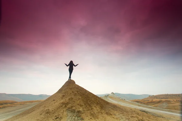 Silhouette of woman meditating on top of a hill — Stock Photo, Image