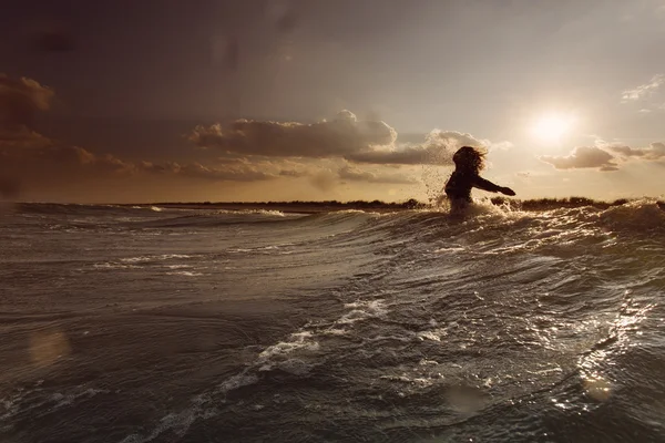 Mujer joven en el mar abrazando el mundo y las olas —  Fotos de Stock