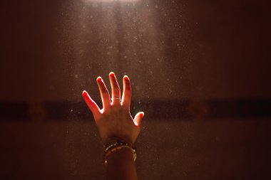 Woman hand into the light