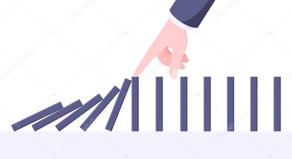 Domino effect business concept. Hand stops chain reaction of falling board game blocks of dominoes.