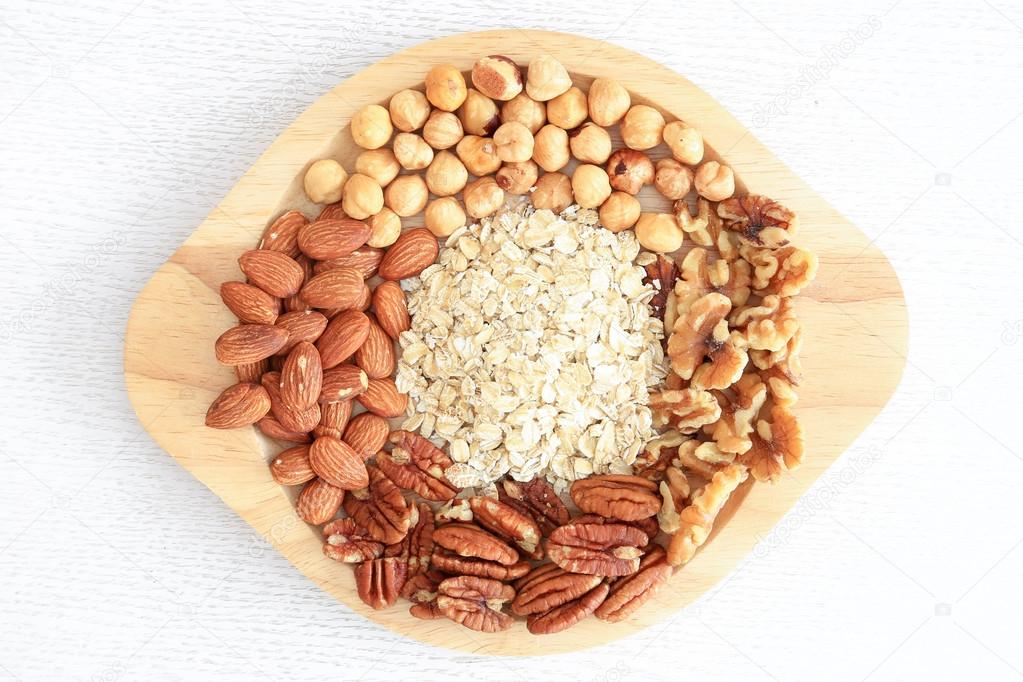 Assortment of beans and lentils in wooden spoon on wooden backgr