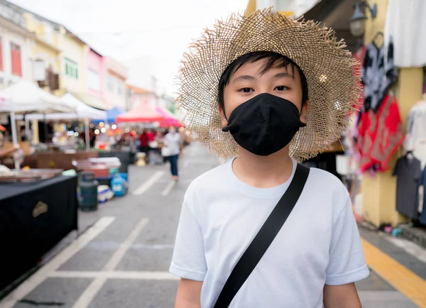 A boy wearing health mask for protect virus during travel new normal