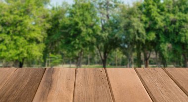 Soyut bulanık bahçe ve ahşap masa desenli yeşil yaprak.