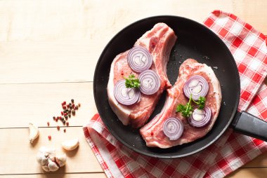 Bir tavada çiğ domuz eti.