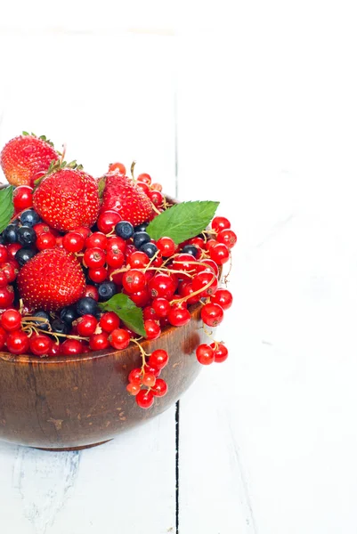 Different berries in wooden bowl — Stock Photo, Image