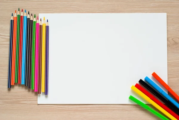 Pencils, crayons and album sheet — Stock Photo, Image