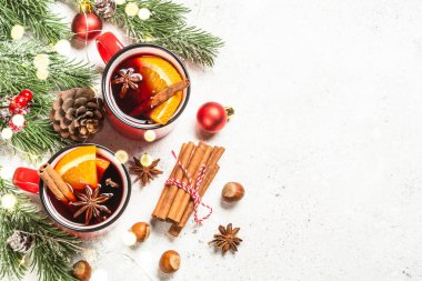 Kırmızı bardaklarda sıcak şarap ve Noel süslemeleri..