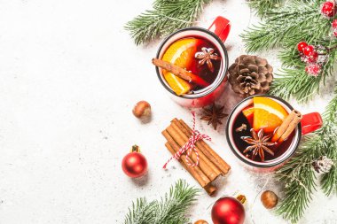 Kırmızı bardaklarda sıcak şarap ve Noel süslemeleri..