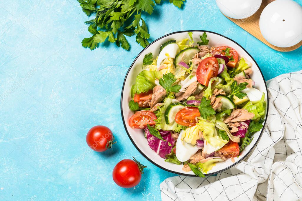 Tuna salad with green leaves, eggs and vegetables.