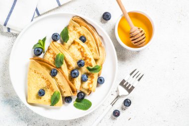 Beyaz masada yaban mersinli krep.