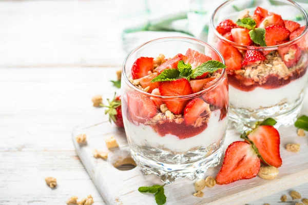 Greek yogurt parfait with strawberry at white table. — Stock Photo, Image