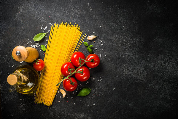 Pasta background. Pasta spaghetti, olive oil, spices, basil and fresh tomatoes.