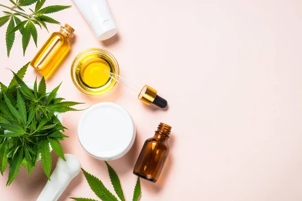 Cannabis oil, cream, soap and fresh leaves at white. — Stock Photo, Image