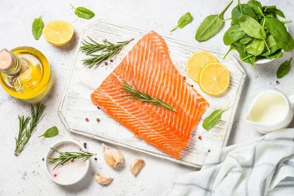 Salmon fillet with rosemary at white. — Stock Photo, Image