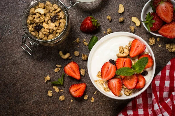 Yogurt with granola and strawberry in white bowl — Stock Photo, Image