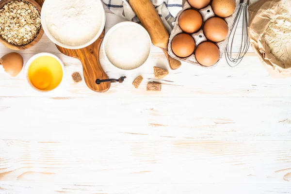 Baking ingredients at white wooden table. — Stock Photo, Image