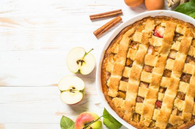 Beyaz ahşap masada zencefilli ve tarçınlı elmalı turta.
