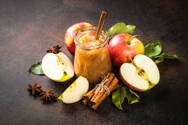 Baharatlı elma reçeli ve koyu arkaplanda taze elma.