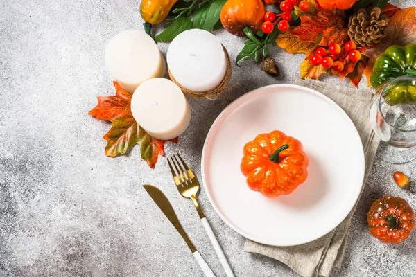 Ajuste de mesa de otoño con plato blanco, velas y decoraciones de otoño. — Foto de Stock
