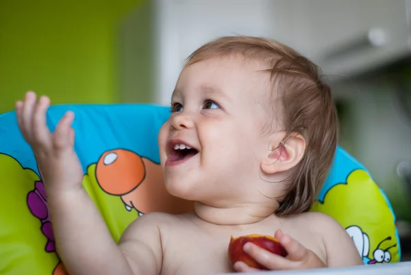Ребенок ест персик — стоковое фото
