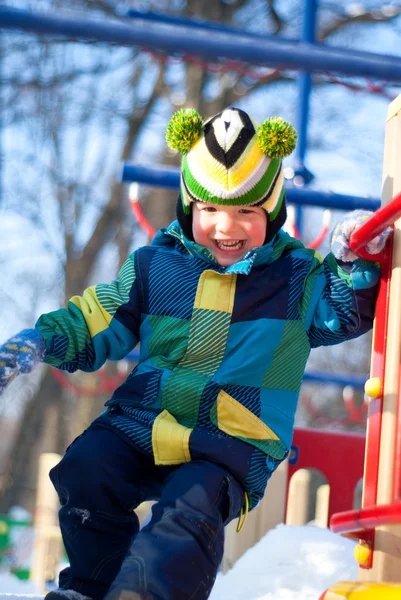 Boy on the playground in winter — Stock Photo, Image