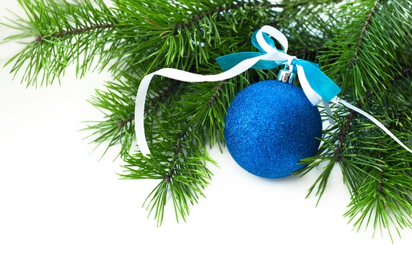 Blue ball with ribbon and Christmas-tree branch Royalty Free Stock Photos