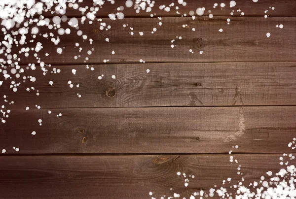 Sněží na pozadí na dřevěné desce — Stock fotografie