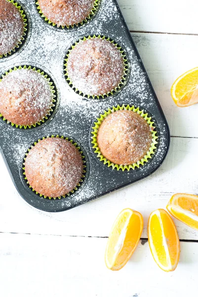 Orange muffins in baking dish — Stock Photo, Image