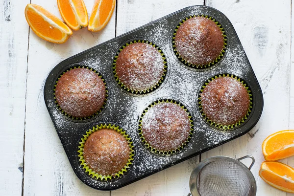 Orange muffins in baking dish — Stock Photo, Image