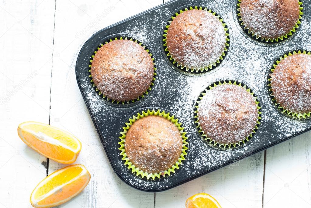 Orange muffins in baking dish